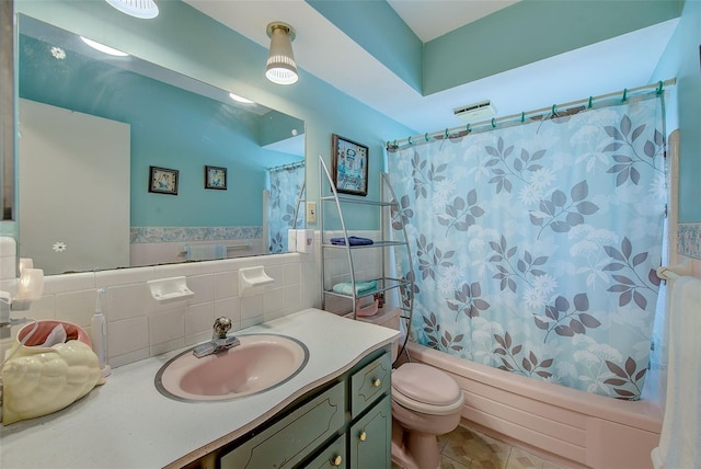 11082 90th Ter, Seminole, FL 33772 - bathroom with vanity, shower / tub combo, a wainscoted wall, tile walls, and tile patterned floors