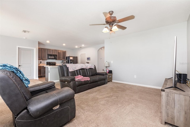 15406 Gopher Trop Pl, Sun City Center, FL 33573 - living room featuring arched walkways, a ceiling fan, light carpet, and recessed lighting