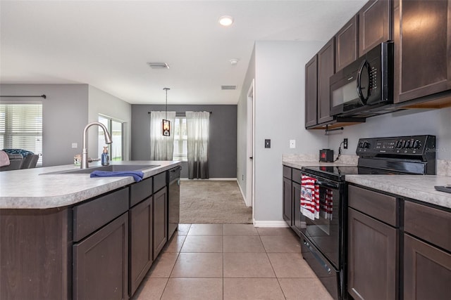 15406 Gopher Trop Pl, Sun City Center, FL 33573 - kitchen with black appliances, light countertops, dark brown cabinetry, light tile patterned floors, and light carpet