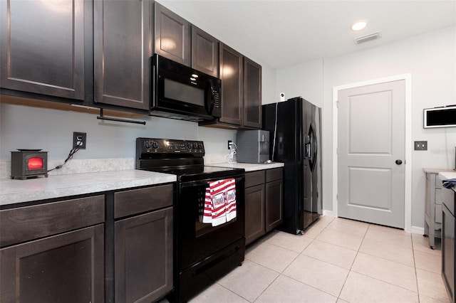 15406 Gopher Trop Pl, Sun City Center, FL 33573 - kitchen with black appliances, light countertops, light tile patterned flooring, and dark brown cabinets