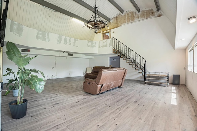 9938 Alavista Dr, Gibsonton, FL 33534 - living area featuring wood finished floors, stairs, a chandelier, beam ceiling, and high vaulted ceiling