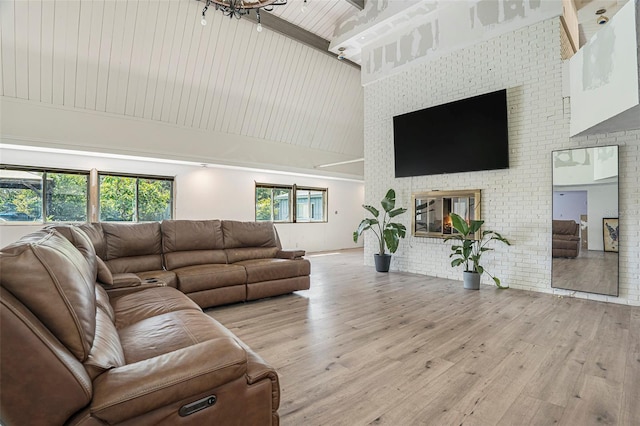 9938 Alavista Dr, Gibsonton, FL 33534 - living area featuring high vaulted ceiling, wood finished floors, a fireplace, brick wall, and beam ceiling