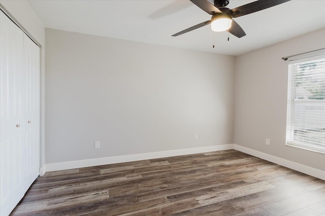 706 E Gate Dr, Safety Harbor, FL 34695 - unfurnished bedroom with a closet, wood finished floors, and ceiling fan