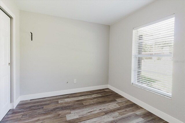 706 E Gate Dr, Safety Harbor, FL 34695 - empty room with wood finished floors and baseboards
