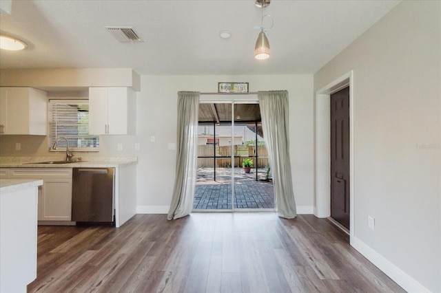 706 E Gate Dr, Safety Harbor, FL 34695 - kitchen featuring dishwasher, light countertops, dark wood finished floors, and white cabinetry