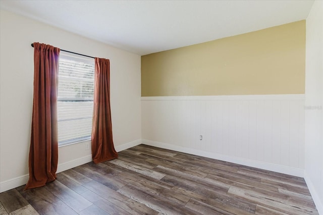 706 E Gate Dr, Safety Harbor, FL 34695 - spare room featuring wood finished floors and a wainscoted wall