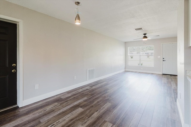 706 E Gate Dr, Safety Harbor, FL 34695 - unfurnished room featuring a ceiling fan, dark wood-type flooring, and a textured ceiling