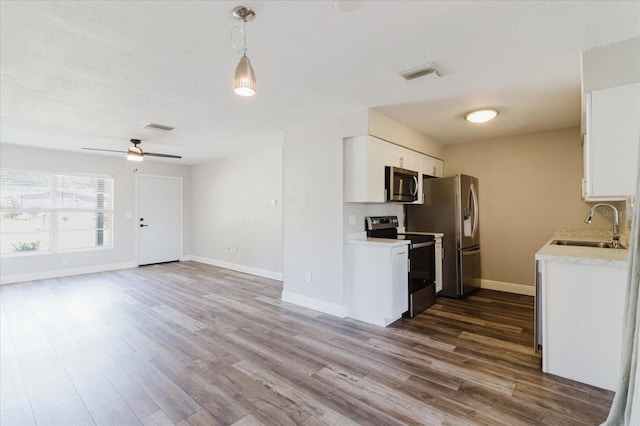 706 E Gate Dr, Safety Harbor, FL 34695 - kitchen featuring appliances with stainless steel finishes, light countertops, and dark wood-style floors