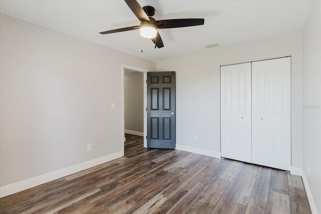 706 E Gate Dr, Safety Harbor, FL 34695 - unfurnished bedroom featuring wood finished floors, a closet, and ceiling fan