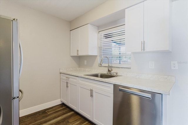 706 E Gate Dr, Safety Harbor, FL 34695 - kitchen featuring stainless steel appliances, dark wood finished floors, white cabinetry, and light countertops