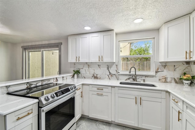 6200 13th Ave, New Port Richey, FL 34653 - kitchen with electric range, white cabinetry, backsplash, a textured ceiling, and a peninsula