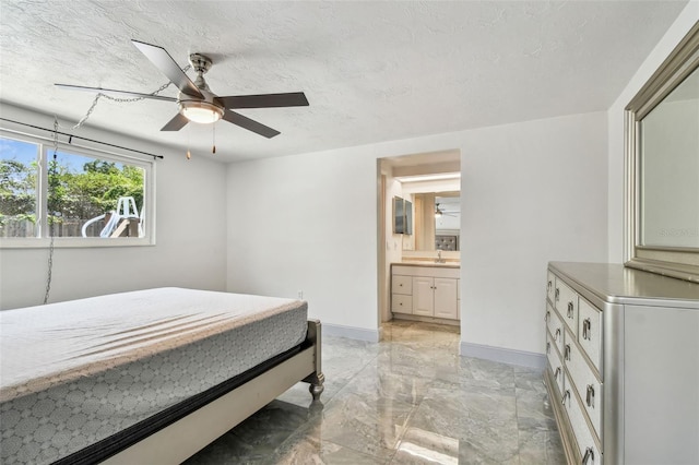 6200 13th Ave, New Port Richey, FL 34653 - bedroom with light marble finish flooring, a textured ceiling, ceiling fan, and ensuite bath