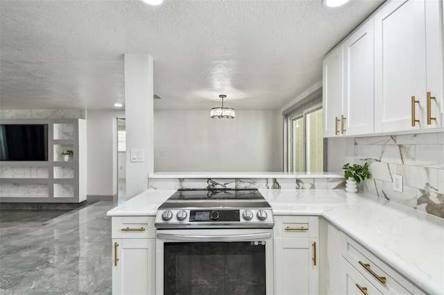 6200 13th Ave, New Port Richey, FL 34653 - kitchen featuring electric range, a textured ceiling, light countertops, white cabinetry, and marble tiled flooring