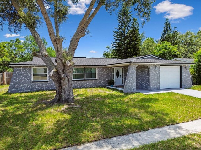 6200 13th Ave, New Port Richey, FL 34653 - ranch-style house with an attached garage, stone siding, and driveway