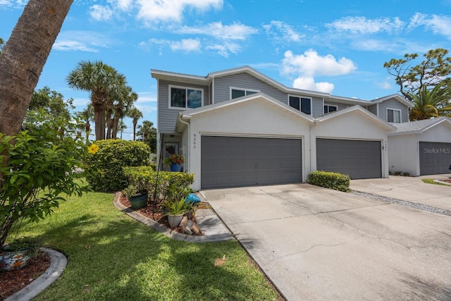 9205 Jakes Path, Largo, FL 33771 - multi unit property with driveway, a garage, a front lawn, and stucco siding