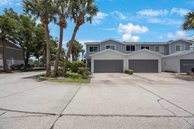 9205 Jakes Path, Largo, FL 33771 - view of front of home with concrete driveway and an attached garage