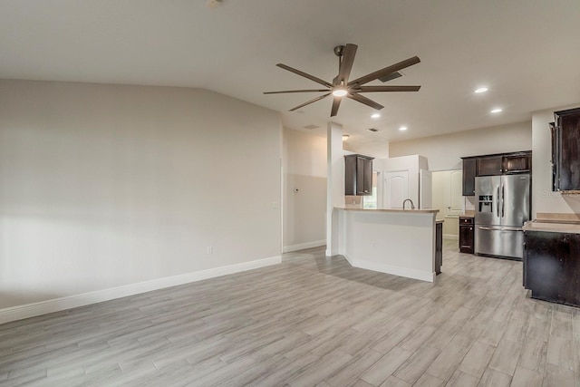 10915 Kirkwall Port Dr, Wimauma, FL 33598 - kitchen with stainless steel refrigerator with ice dispenser, ceiling fan, lofted ceiling, light wood-style floors, and open floor plan