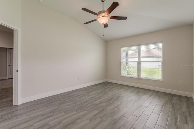 10915 Kirkwall Port Dr, Wimauma, FL 33598 - empty room with light wood finished floors, a ceiling fan, and lofted ceiling