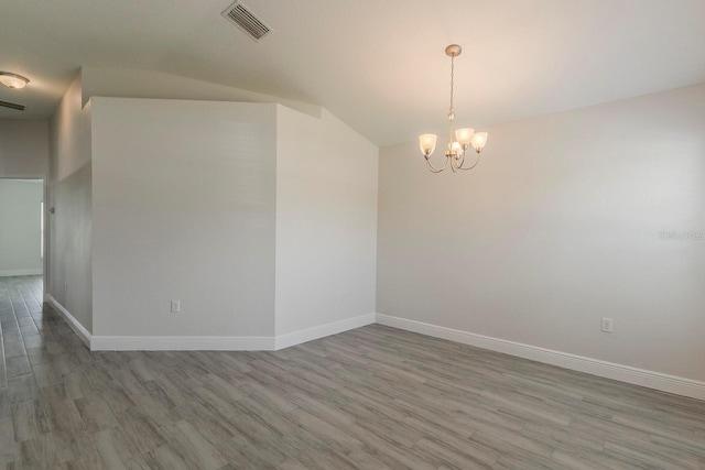 10915 Kirkwall Port Dr, Wimauma, FL 33598 - unfurnished room with a chandelier, wood finished floors, and lofted ceiling