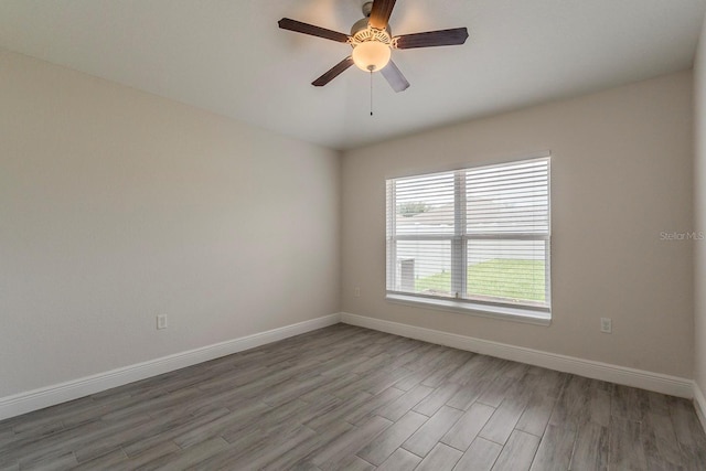 10915 Kirkwall Port Dr, Wimauma, FL 33598 - spare room with wood finished floors and ceiling fan