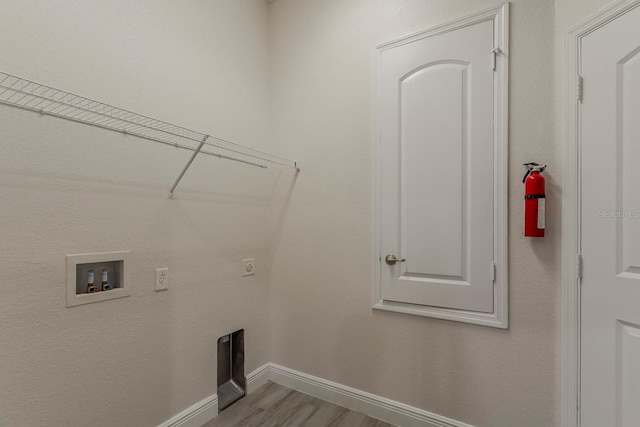 10915 Kirkwall Port Dr, Wimauma, FL 33598 - laundry area featuring hookup for an electric dryer, washer hookup, and wood finished floors