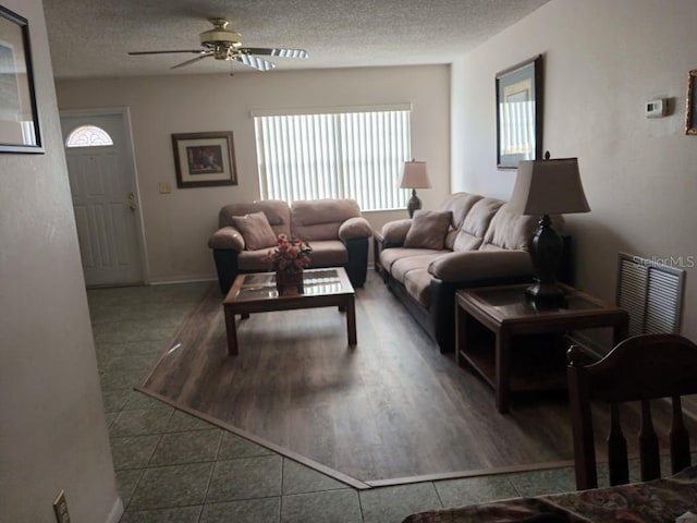 432 Flamingo Dr, Apollo Beach, FL 33572 - tiled living room featuring a ceiling fan, healthy amount of natural light, and a textured ceiling