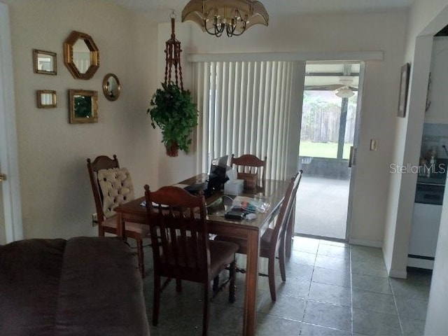 432 Flamingo Dr, Apollo Beach, FL 33572 - dining area featuring a chandelier and light tile patterned floors