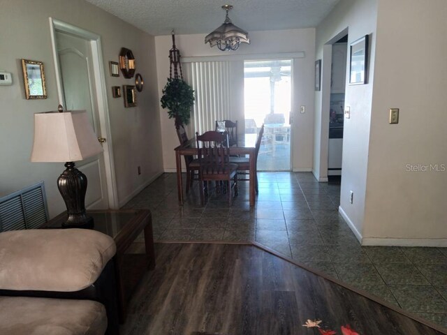 432 Flamingo Dr, Apollo Beach, FL 33572 - dining space featuring tile patterned floors, a chandelier, and a textured ceiling