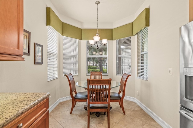 4911 Rock Island Ct, Wimauma, FL 33598 - dining room featuring a chandelier, healthy amount of natural light, and light tile patterned flooring