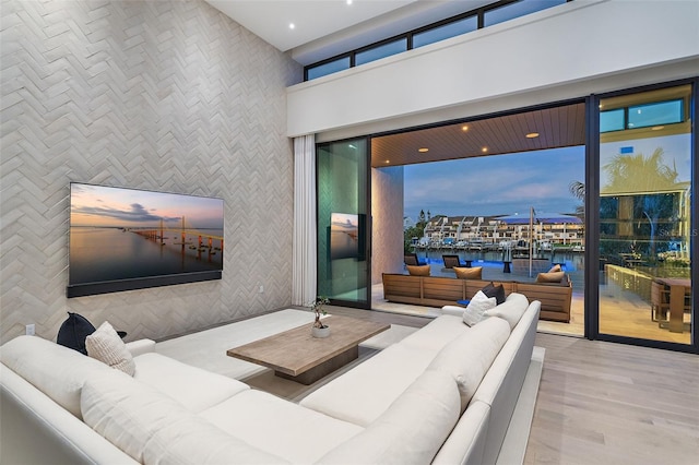 501 Barcelona Dr, Tierra Verde, FL 33715 - living room featuring a water view, wood finished floors, a high ceiling, healthy amount of natural light, and recessed lighting
