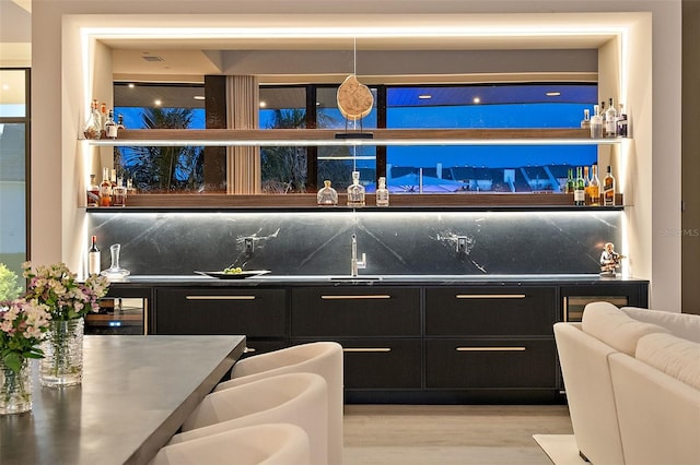 501 Barcelona Dr, Tierra Verde, FL 33715 - indoor wet bar with backsplash, light wood-type flooring, and wine cooler