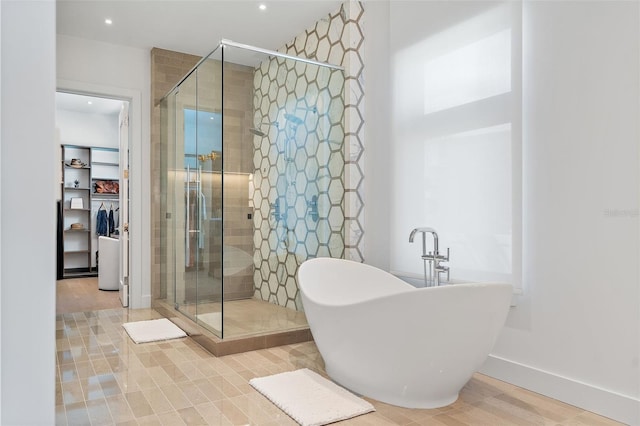 501 Barcelona Dr, Tierra Verde, FL 33715 - full bathroom featuring a shower stall, a soaking tub, recessed lighting, and a spacious closet