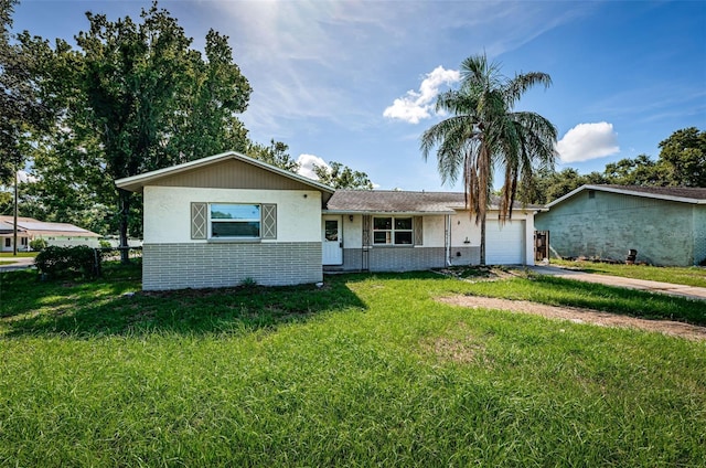 2003 Whispering Pines St, Largo, FL 33774 - view of front facade featuring an attached garage, driveway, and brick siding
