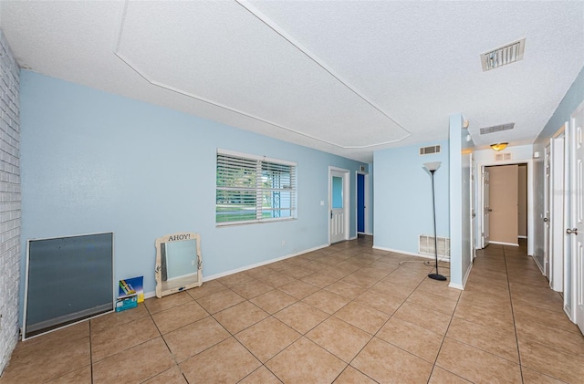 2003 Whispering Pines St, Largo, FL 33774 - spare room with light tile patterned floors and a textured ceiling