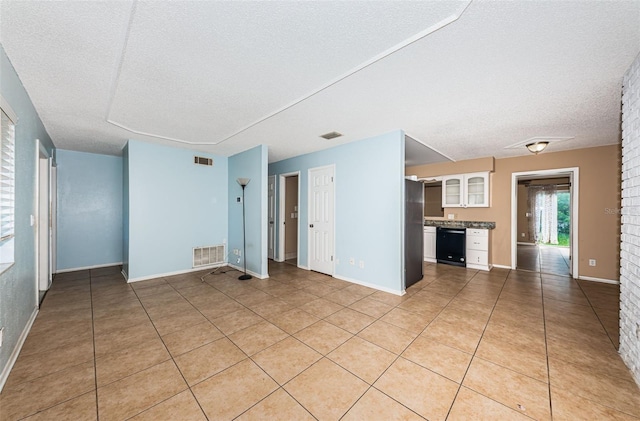 2003 Whispering Pines St, Largo, FL 33774 - unfurnished living room with a textured ceiling and light tile patterned flooring