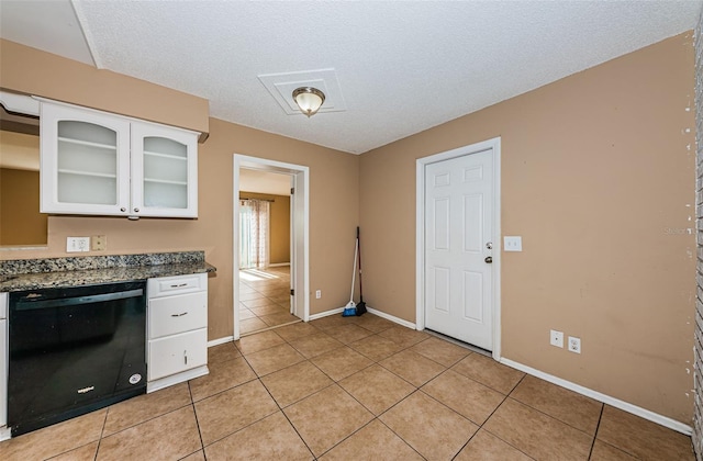 2003 Whispering Pines St, Largo, FL 33774 - kitchen featuring dishwasher, white cabinets, light tile patterned floors, glass insert cabinets, and dark countertops