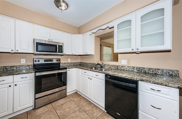 2003 Whispering Pines St, Largo, FL 33774 - kitchen featuring appliances with stainless steel finishes, glass insert cabinets, and white cabinets