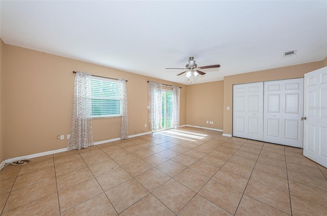 2003 Whispering Pines St, Largo, FL 33774 - unfurnished bedroom with a closet, light tile patterned floors, and a ceiling fan