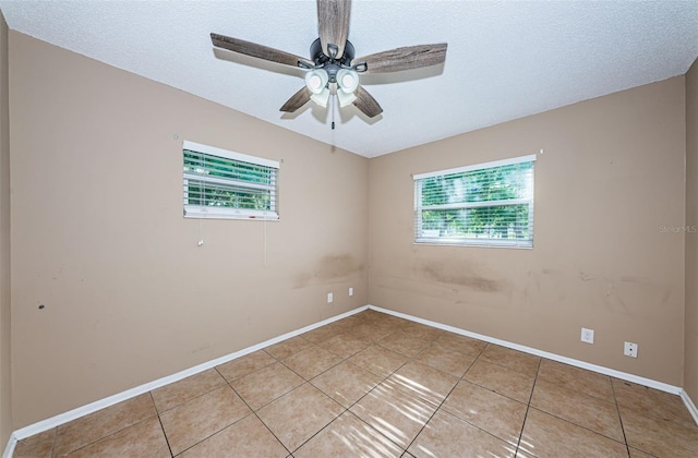 2003 Whispering Pines St, Largo, FL 33774 - empty room featuring light tile patterned floors, a ceiling fan, and a textured ceiling