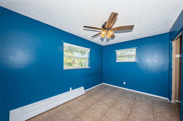 2003 Whispering Pines St, Largo, FL 33774 - spare room with a textured ceiling, ceiling fan, plenty of natural light, and tile patterned floors