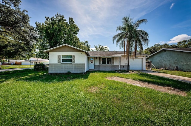 2003 Whispering Pines St, Largo, FL 33774 - ranch-style house with a garage, brick siding, a front lawn, and driveway