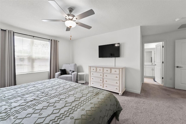9815 Carabiner Way, Land O Lakes, FL 34637 - carpeted bedroom featuring a textured ceiling, a ceiling fan, and ensuite bath