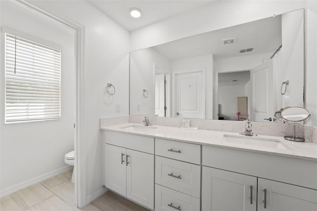 9815 Carabiner Way, Land O Lakes, FL 34637 - bathroom featuring double vanity and toilet