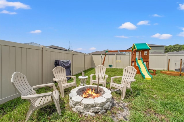 9815 Carabiner Way, Land O Lakes, FL 34637 - fenced backyard with a fire pit and a playground