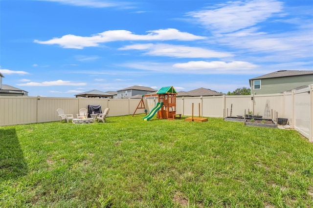 9815 Carabiner Way, Land O Lakes, FL 34637 - fenced backyard featuring a playground, a garden, and an outdoor fire pit