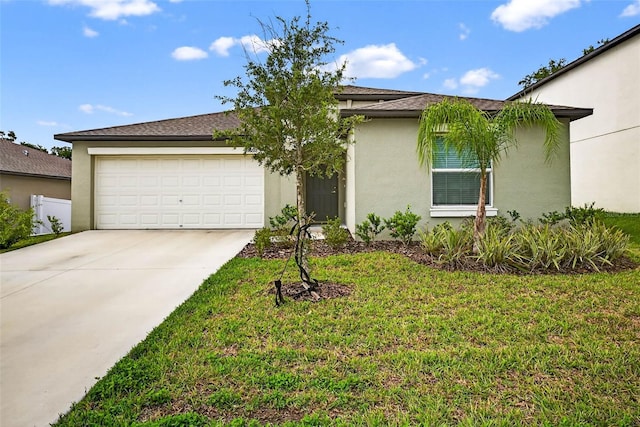 36618 Garden Wall Way, Zephyrhills, FL 33541 - view of front of house featuring stucco siding, concrete driveway, a garage, and a front lawn