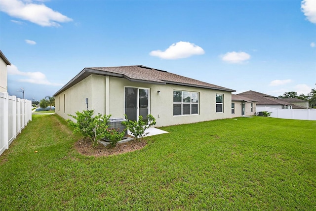 36618 Garden Wall Way, Zephyrhills, FL 33541 - back of property with stucco siding and roof with shingles