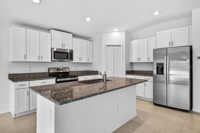 36618 Garden Wall Way, Zephyrhills, FL 33541 - kitchen with appliances with stainless steel finishes, white cabinetry, light tile patterned flooring, dark stone countertops, and recessed lighting