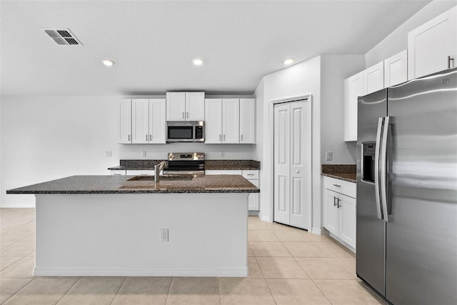 36618 Garden Wall Way, Zephyrhills, FL 33541 - kitchen with stainless steel appliances, light tile patterned floors, white cabinets, dark stone counters, and recessed lighting