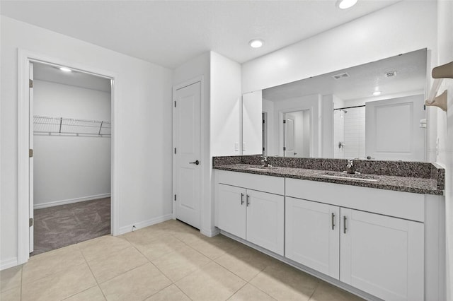 36618 Garden Wall Way, Zephyrhills, FL 33541 - bathroom with a stall shower, double vanity, a spacious closet, tile patterned floors, and recessed lighting
